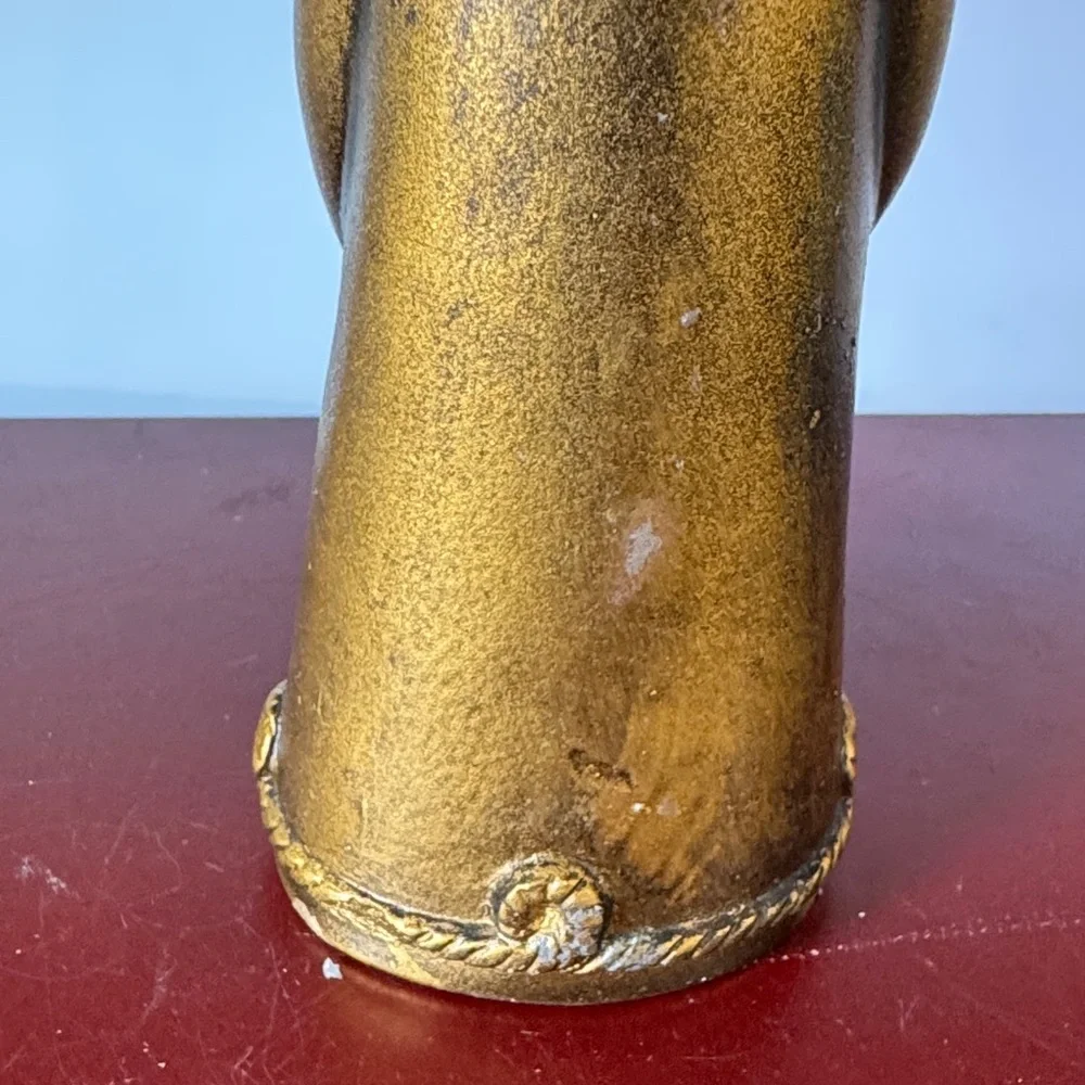 vintage chalkware candle holder featuring a metallic gold-finished figure